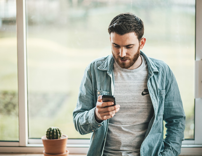 Man looking down at phone