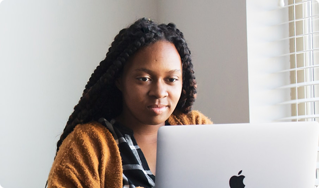 African American woman looking at laptop